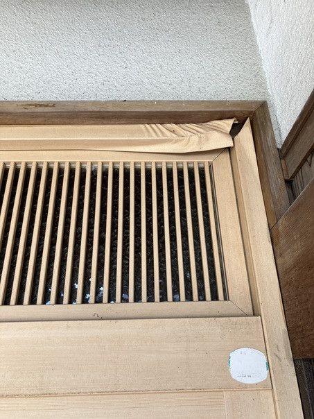 小林エコ建材の檜調ラッピング玄関からアルミ色の引戸への施工前の写真2