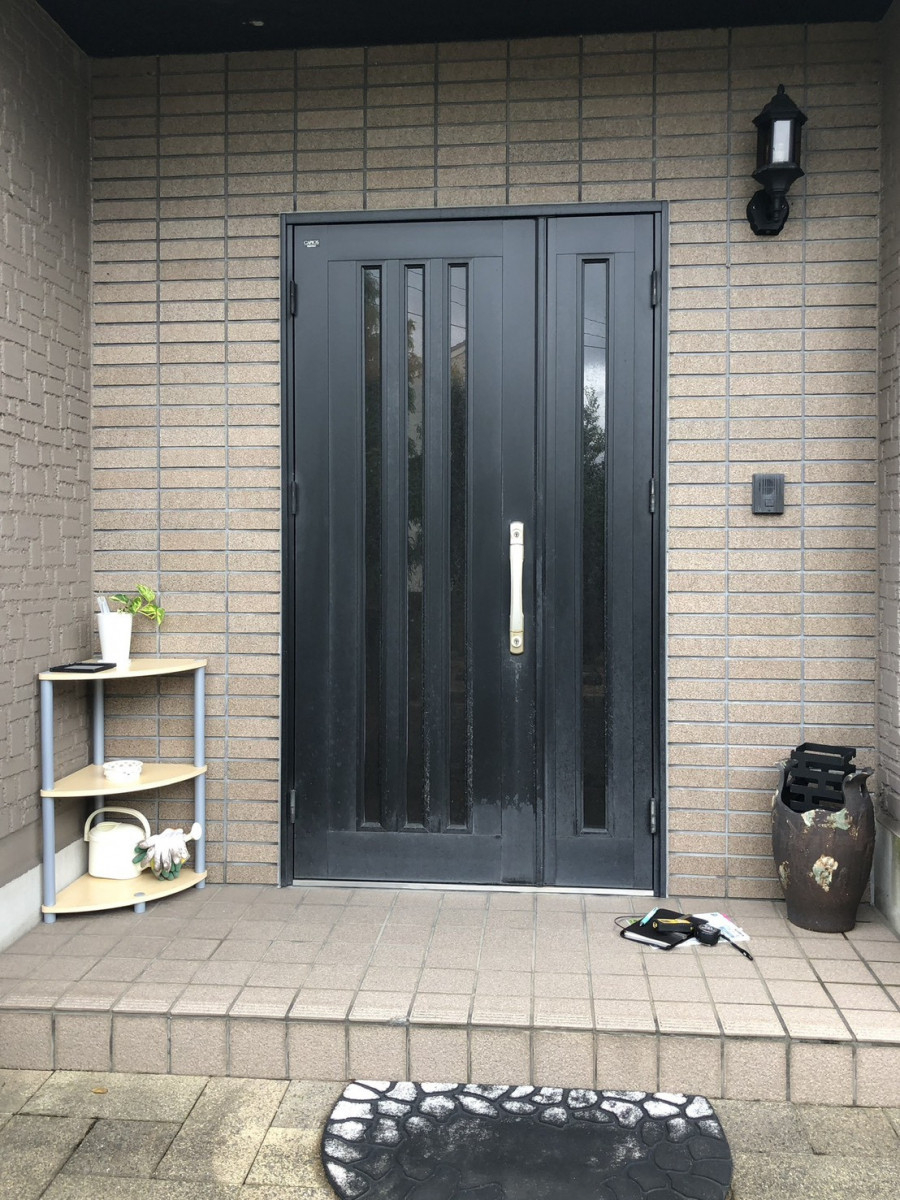 イワイの【敦賀市 玄関ドア1dayリフォーム】黒い玄関を白い木目調へ｜カバー工法＋電池錠で快適アップの施工前の写真1